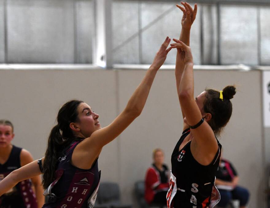 Horsham Demon Romi Miller contests Saints' Abby Hallam's shot during the 2023 Anzac match on Sunday, April 23, 2023. Picture by Lucas Holmes