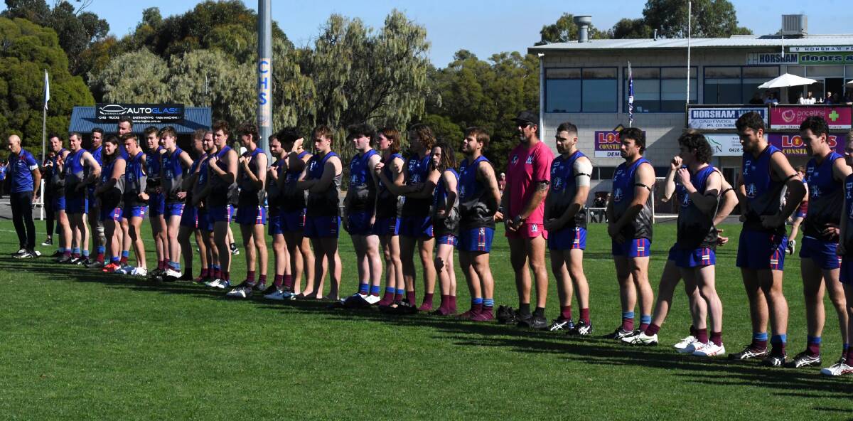 Members of the Horsham Demons observe the pre-match Anzac ceremony in 2023. Picture file