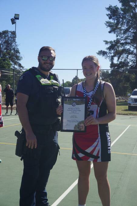Edenhope Apsley 17 and under netballer Layla Linto receives her Blue Ribbon Spirit of Netball award from Edenhope police officer Senior Constable Issac Mauro. Picture supplied 