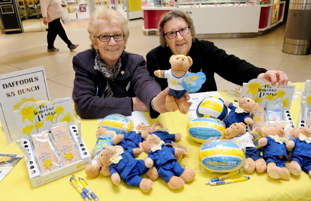 GENEROUS: Horsham Cancer Council members June Jelly and Elaine Shearwood selling items for Daffodil Day. Picture: SAMANTHA CAMARRI