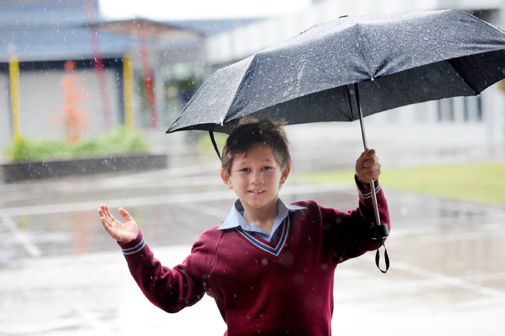 POURING: Horsham's Holy Trinity Lutheran School student Edward Jones enjoys the rain earlier this month. Picture: SAMANTHA CAMARRI
