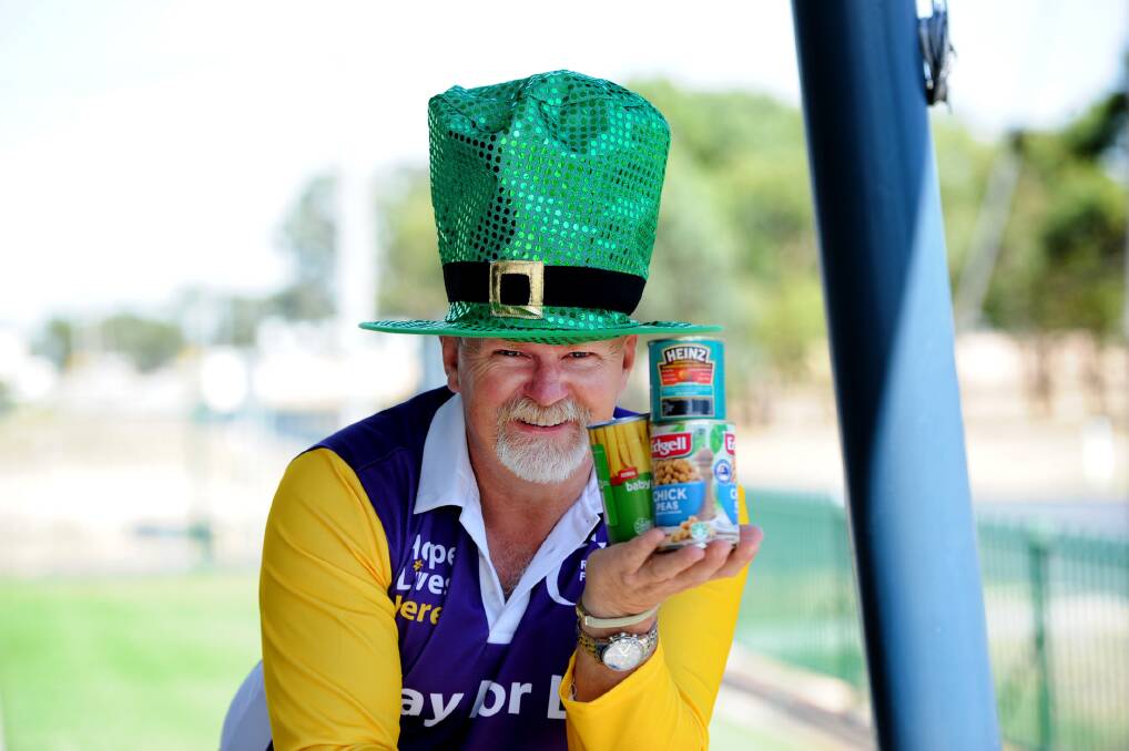 GENEROUS: Horsham and District Relay For Life chairmanager Kingsley Dalgleish encourages people to donate cans of food at this year's event. Picture: SAMANTHA CAMARRI