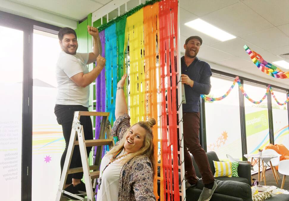 Loucas Vettos, Emma Hynes and Beau Ladlow hang rainbow decorations at headspace Horsham in support of LGBTI youth.