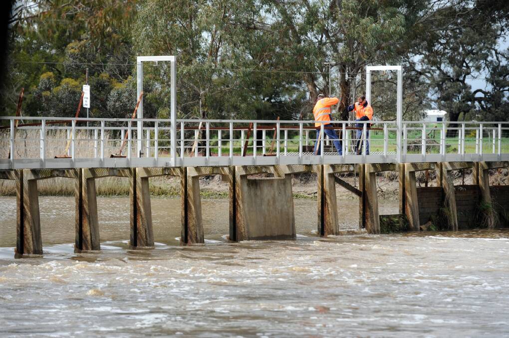 Council workers remove weir boards at Horsham Weir.