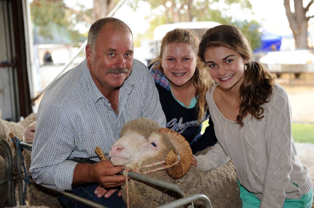 Judge Kevin Beaton gives contestants Alanna Miller, Glenpaen, and Lucy Russell, Melrose, tips in a junior sheep judging comp at Balmoral Show in 2013.