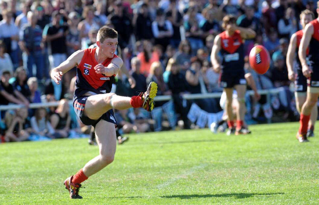 POISE: Tom Crawford gets his kick away for Mountain Men in the 2014 grand final, which the Mountain Men loss in a shock upset to Harrow-Balmoral.