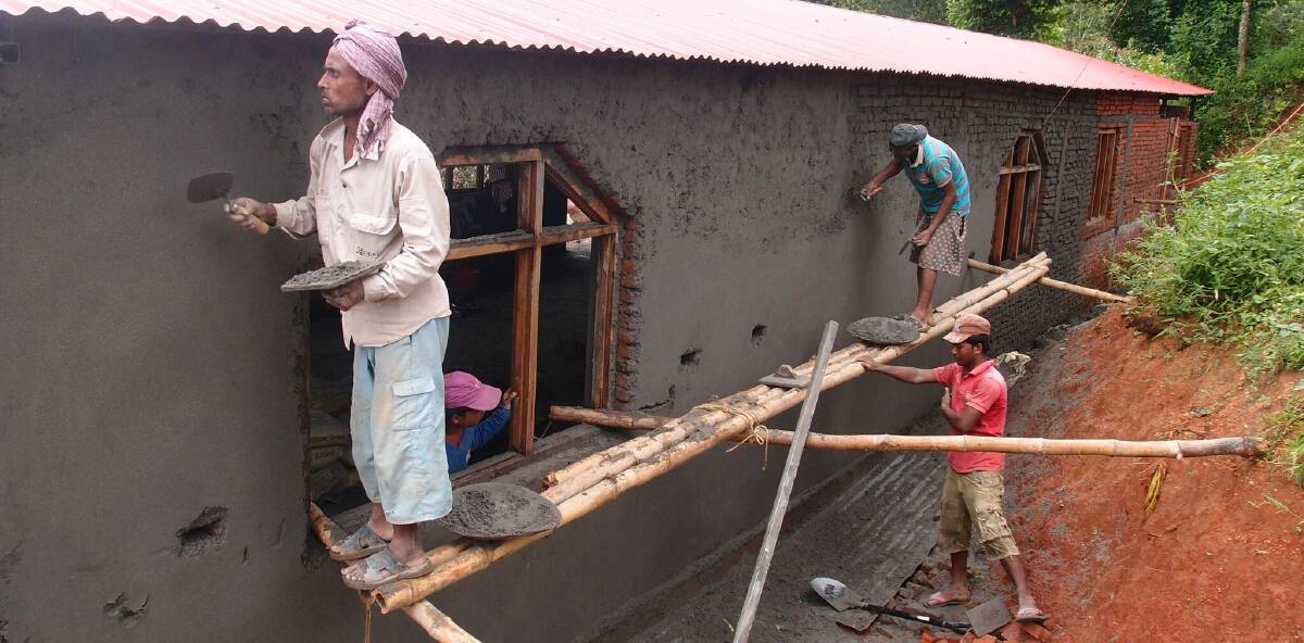 UNDERWAY: Workers build the community centre at the earthquake damaged town of Aapghari in Nepal.