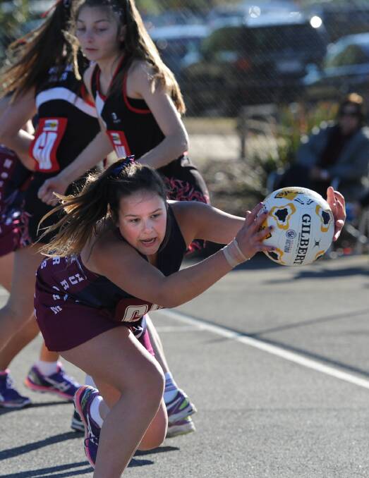 STRETCH: Horsham's Hayley Pope reaches for the ball in the 2014 13 and under grand final. Picture: SAMANTHA CAMARRI