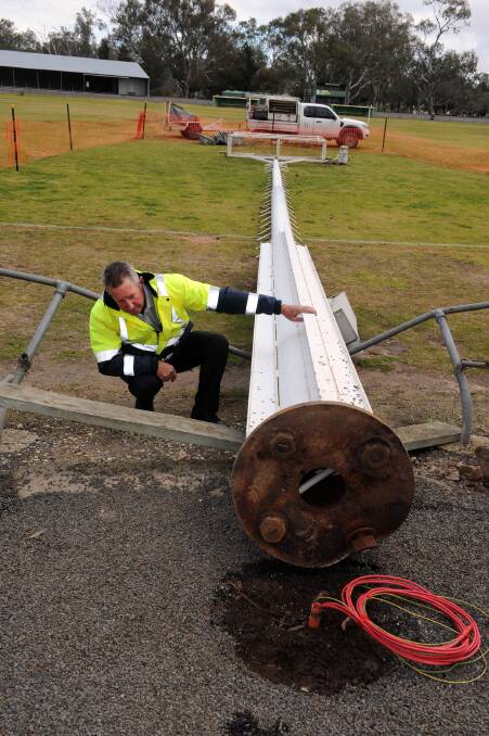 TOPPLED: Hindmarsh Shire Council's contracts manager Wayne Schulze inspects a fallen light tower at Dimboola Recreation Reserve in July. Picture: PAUL CARRACHER