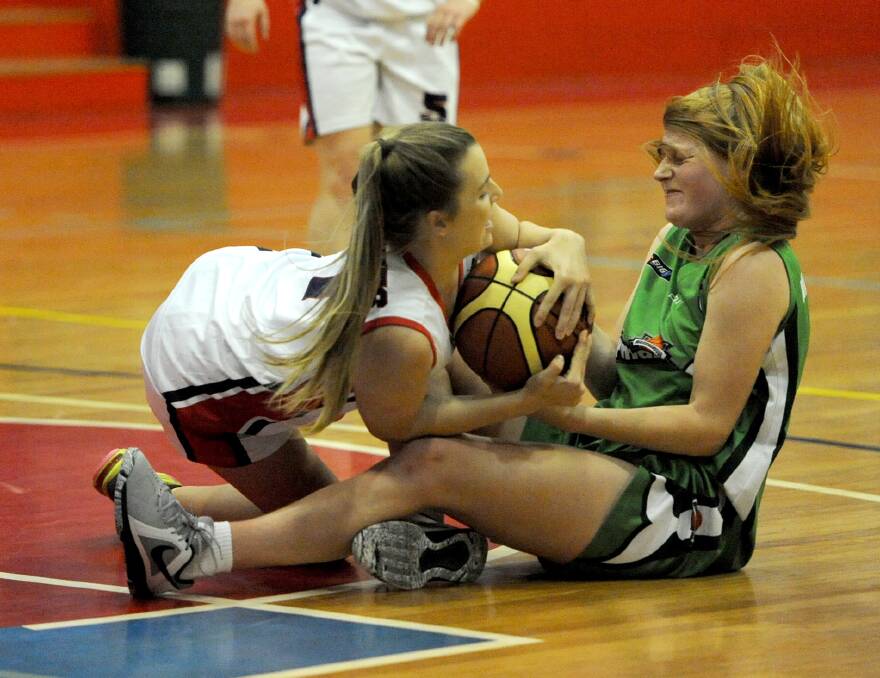TUSSLE: Horsham's Georgia Hiscock battles with Warrnambool's Eliza Killey during a match in October. Picture: SAMANTHA CAMARRI
