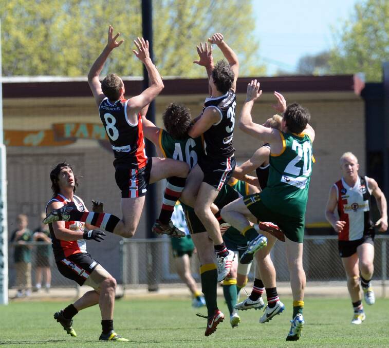 FLY: A pack of players sour for a mark during the 2014 reserves grand final. Pictures: PAUL CARRACHER