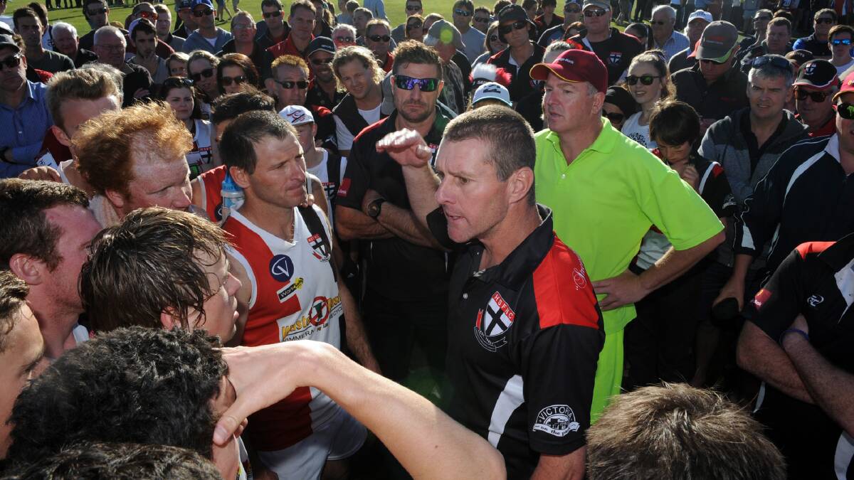INTENT: Saints coach Shayne Breuer speaks to his players during the 2014 grand final. Picture: PAUL CARRACHER