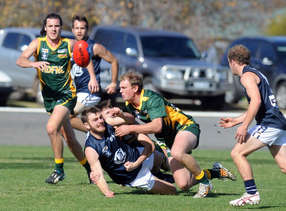 CAUSE FOR CONCERN: Pimpinio's Daniel Baker, pictured laying a tackle for Horsham District Football Netball League's interleague side this year, suffered fractures to his neck at the weekend, which has seen the league launch an investigation into the incident that caused the injuries. Picture: PAUL CARRACHER