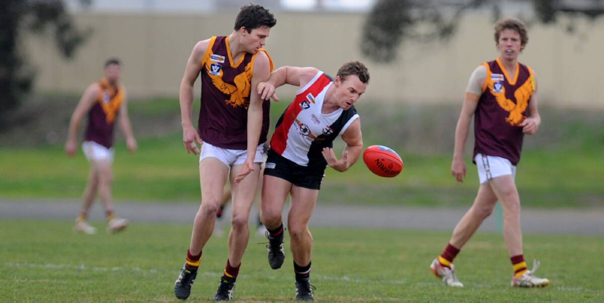 HARD-FOUGHT: Warrack Eagles' Jae McGrath opposes Horsham Saints' Nathan Byrne at the weekend. McGrath was named as one of the Eagles' best during a tough match against the Saints. Picture: SAMANTHA CAMARRI