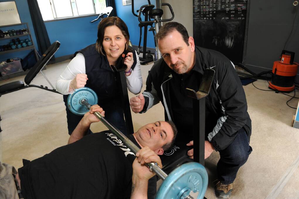COMMIT TO FIT: Sarah Laurie and Chris Van Buuren, both of Horsham, offer their trainer Brad Wade some encouragement. Mrs Laurie and Mr Van Buuren won 12 weeks of personal training at Forward Fitness. Picture: PAUL CARRACHER