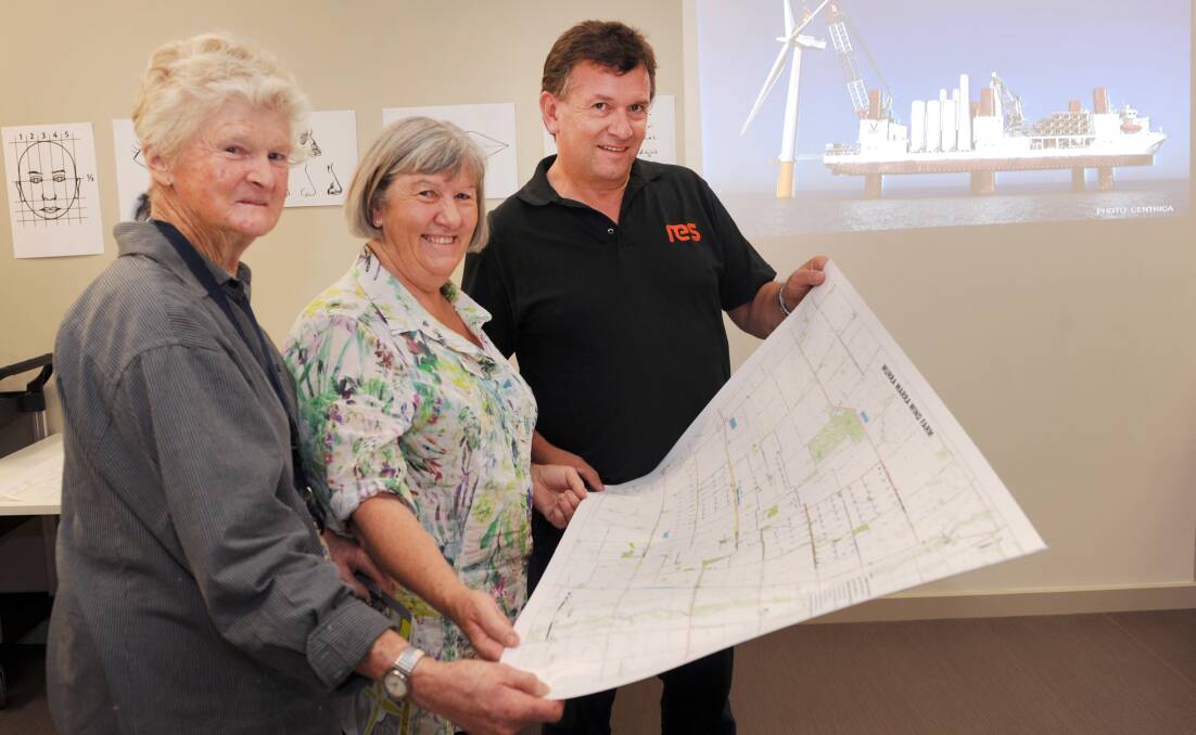 INFORMATIVE: Kola Kennedy, Heather Phillips and Kevin Garthwaite discuss the proposed Murra Wurra Wind Farm on Monday. Picture: PAUL CARRACHER