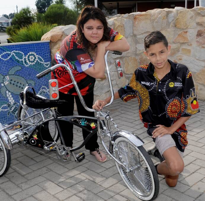 Kayla Kennedy and Claudie Douglas with the Deadly Beast Trike built as part of the Deadly Bikes project. Picture: SAMANTHA CAMARRI