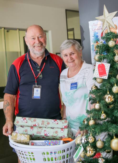 Volunteers Bill Goodwin and Kathy Brown collecting gifts.