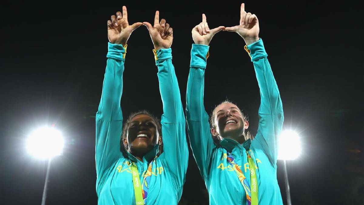 DAY 3: Ellia Green (L) of Australia and her team mate Chloe Dalton pose with her Gold medal after the medal ceremony for the Women's Rugby Sevens on Day 3 of the Rio 2016 Olympic Games at the Deodoro Stadium on August 8, 2016 in Rio de Janeiro, Brazil. Photo: Alexander Hassenstein/Getty Images