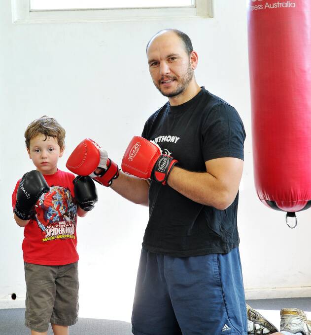 DRIVEN: Wagga boxer Anthony McCracken is joined by son Brock, 2, at training. The cruiserweight is keen to resume his career after a long lay-off. Picture: Kieren L Tilly