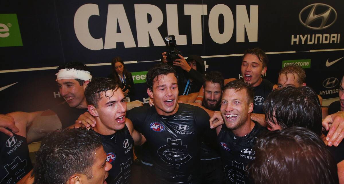CHEERS: Sam Petrevski-Seton, Tom Williamson, Jack Silvagni and Rhys Palmer sing the song to celebrate the Blues' narrow win against Essendon on Sunday. Picture: Getty Images