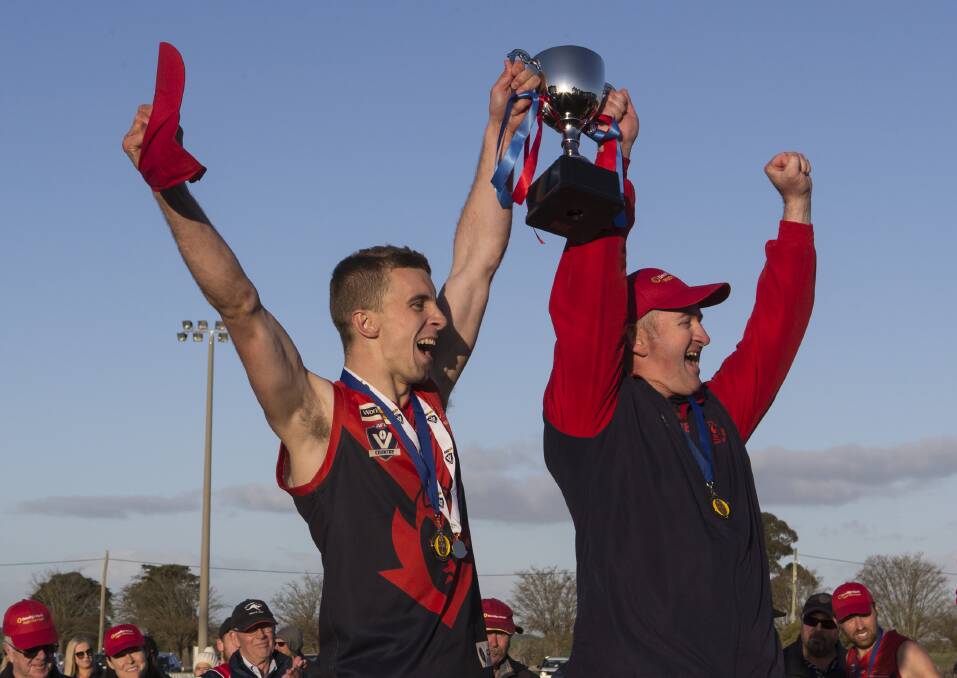 CHAMPIONS: Lismore-Derrinallum captain Michael Lockyer and coach Jahn Knight hold the premiership cup aloft after their grand final win. Picture: Peter Pickering