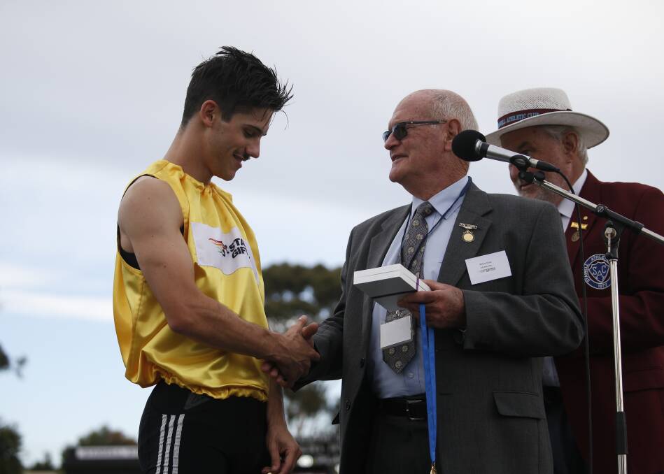 WINNER: Bill Earle presenting the gold medal to last year's Stawell Gift winner, Matt Rizzo. Earle will be presenting the medal to this year's winner as well.