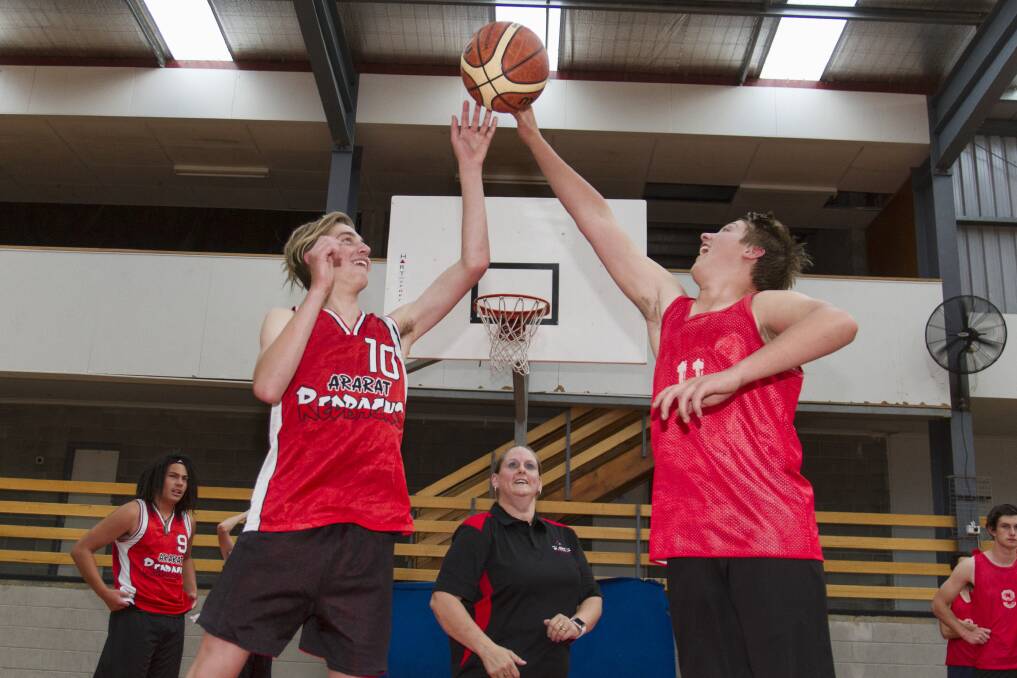 PROGRESS: Ararat Basketball Association president Donna Dunmore throws up the jump ball for Hamish Lawrie and Logan Spark. Picture: Peter Pickering