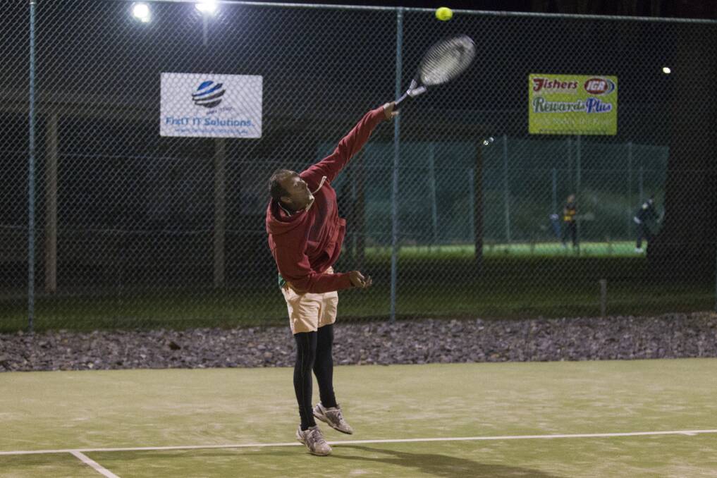 Long reach: Michael Hope attempting a lob on the courts of the Ararat City Tennis Club on Wednesday night, returning to play after they were washed out last week. Picture: Peter Pickering. 