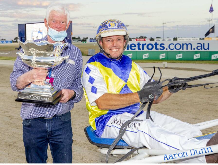 WINNER: Horsham owner-trainer driver Aaron Dunn (right)
is all smiles after winning the Victorian-bred three-year-old
colts and geldings series final on Bondi Lockdown.
Picture: STUART McCORMICK/RACE DAY PHOTOS 