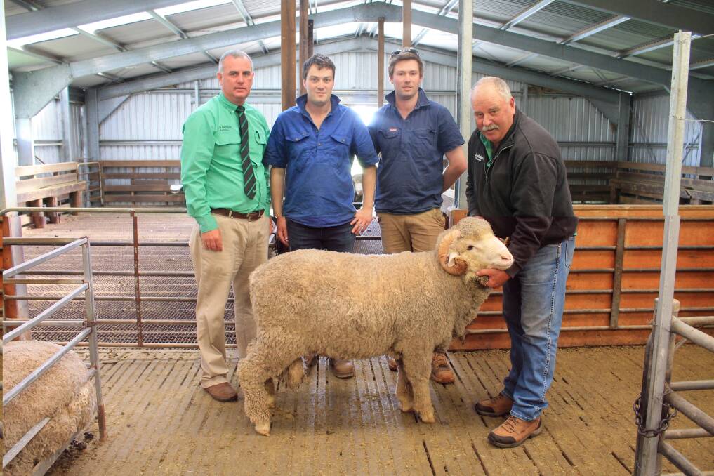 Nutrien south-east stud stock manager Peter Godbolt, Chris and Ben Hartwich, Mount Challicum Merino stud, Ballyrogan, and Nutrien agent Kevin Beaton, with Lot 8, one of the two top-priced $10,000 Rock-Bank rams. Picture by Philippe Perez