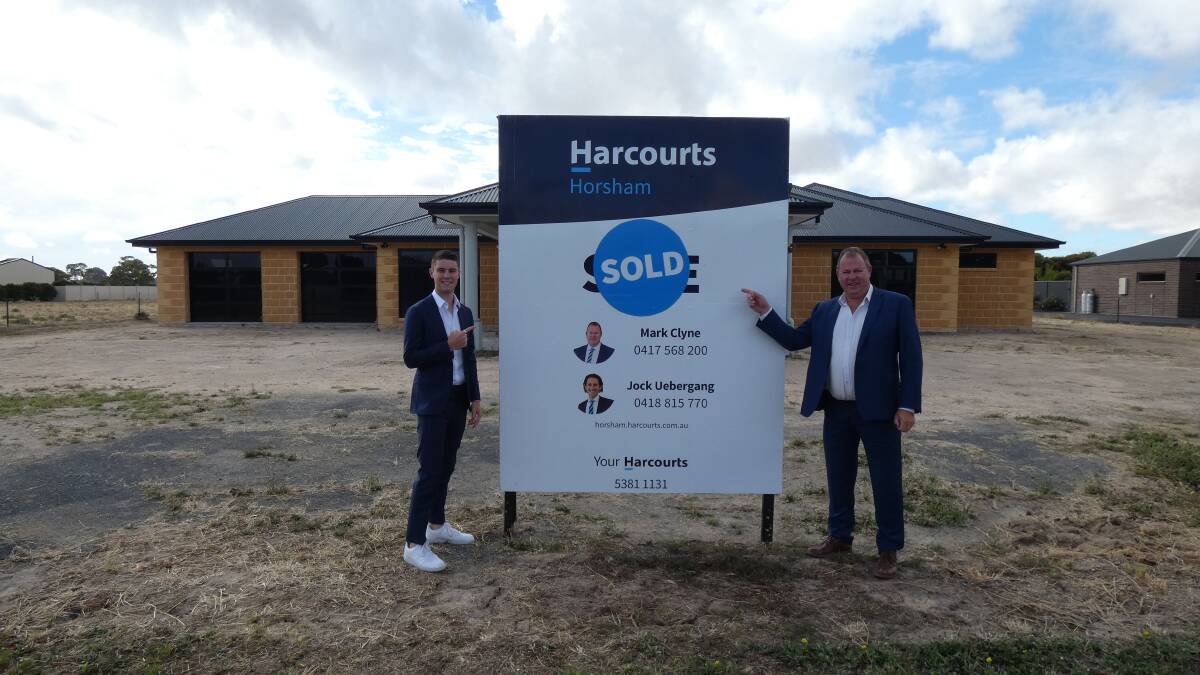 DONE: Jock Uebergang and Mark Clyne in front a recently sold home. Picture: CONTRIBUTED