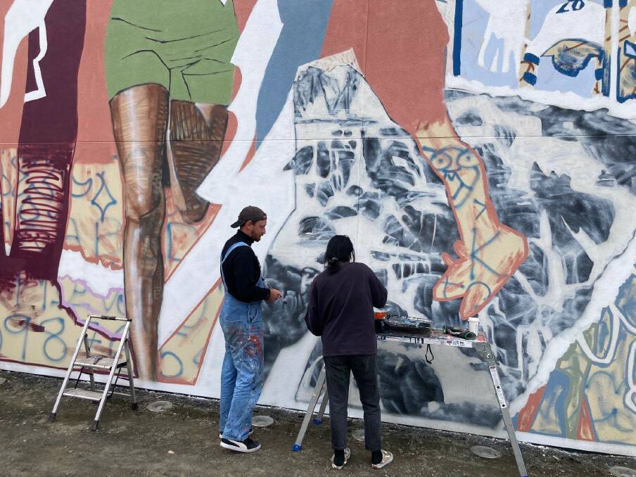 Brisbane artists Maxim Chikanchi and Rozelle Tan of MCRT Studio working on Central Park mural art project, which focuses on female participation in sports. Picture supplied