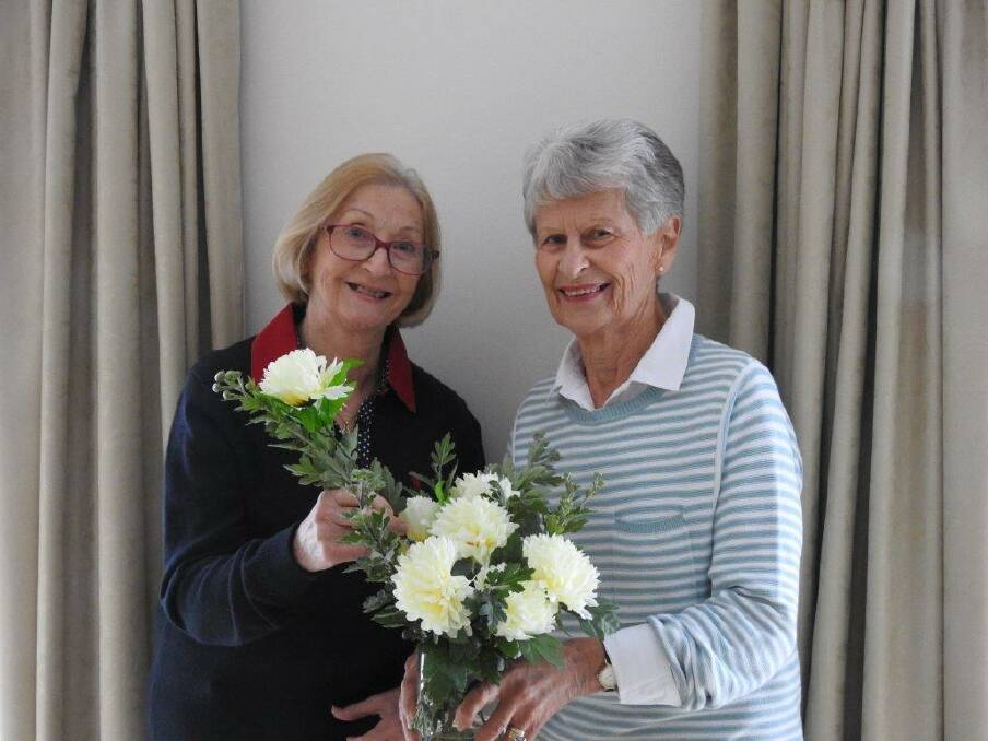 COMMUNITY: THE Wimmera Hospice Care Auxiliary's Judy Garwood and Nola Bellinger with locally grown Chrysanthemums available for sale until May 7. Picture: CONTRIBUTED