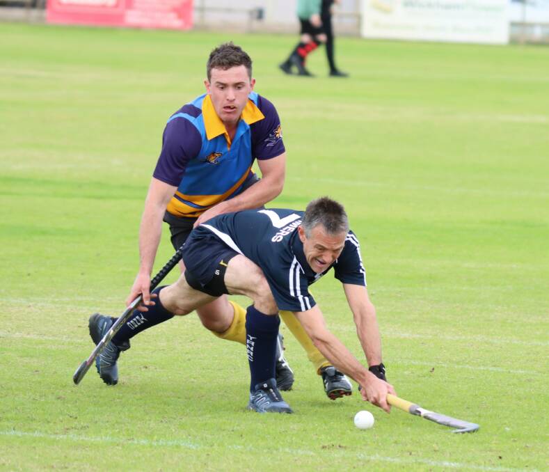 TEXTBOOK: Simon Farmers (front) cracks a backhander whilst under pressure from Sam Bone. Picture: CONTRIBUTED