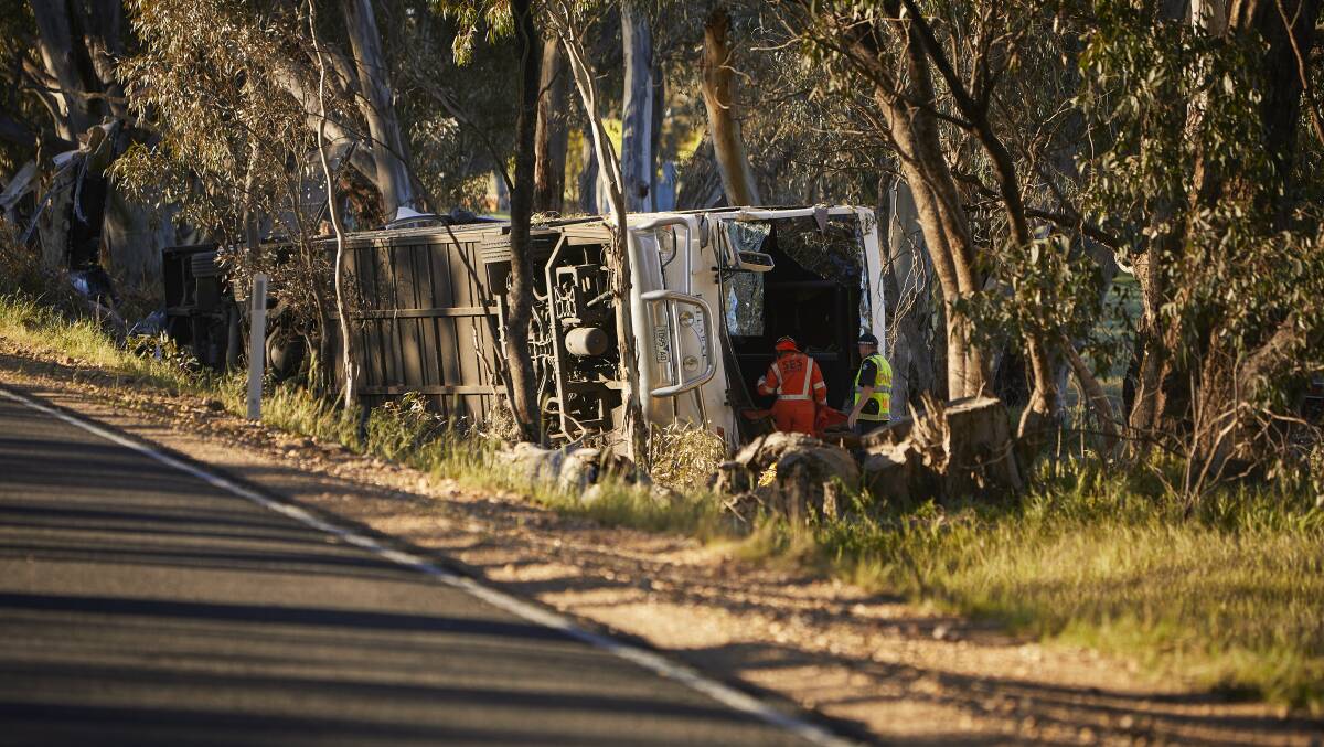Police and SES workers inspect the bus near Avoca. Picture: Luka Kauzlaric 