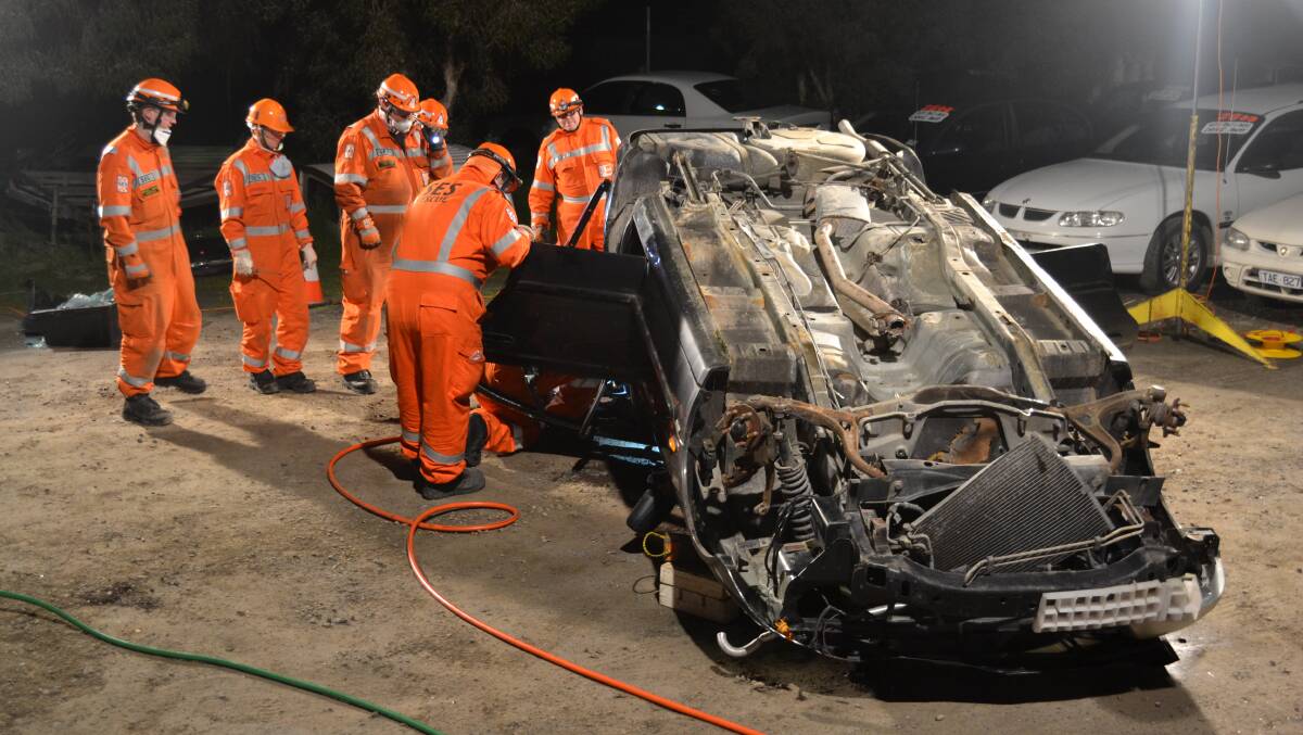 TRAINING: New members from the Horsham SES unit use a car donated by Horsham Auto Wreckers' owner Gilbert Membry to undertake their road crash rescue training. Picture: CONTRIBUTED. 
