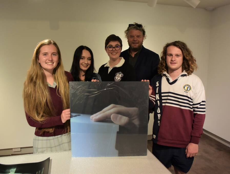 PHOTOGRAPHY: Rachel Kemp, Lilly Martin, Madeleine Trudel, Adam Harding and Baillie Farley with a piece of artwork that will be featured in the Exposed: Perceptions in Photography exhibition. Picture: DAINA OLIVER