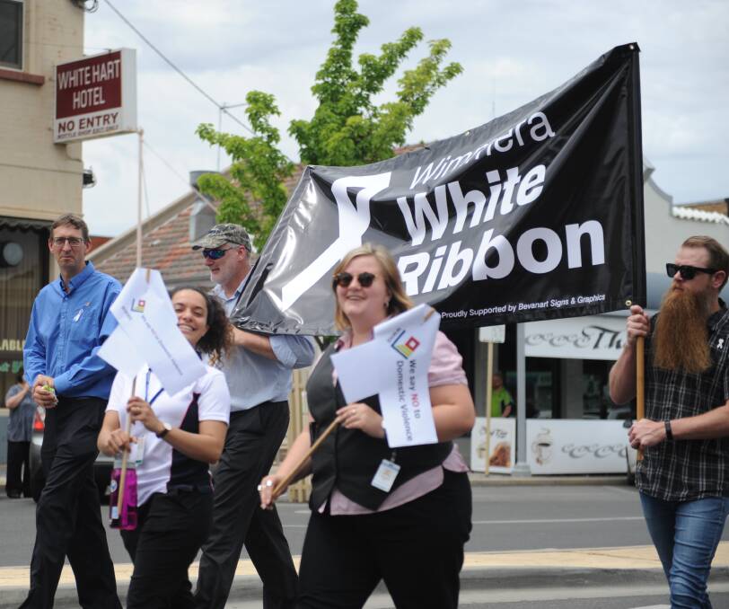 The community walks together to support White Ribbon Day