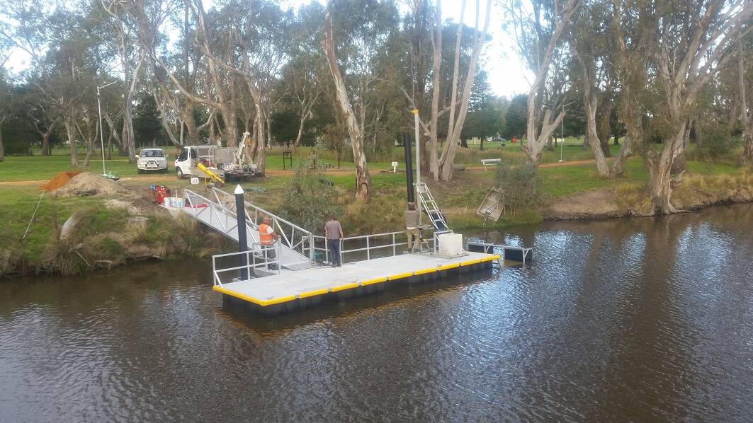 BOATING: Contractors completing the installation on the new boating pontoon to provide easy access to the Wimmera River. Picture: CONTRIBUTED.