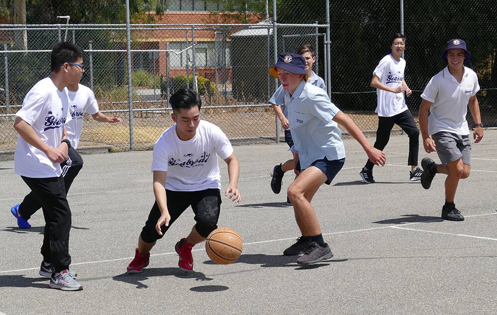 HAVING FUN: GoAbroad education chinese high school students playing basketball with Horsham College students. Picture: CONTRIBUTED