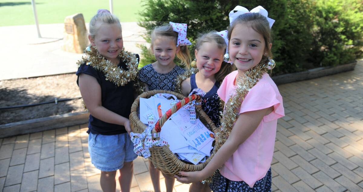 FESTIVE: Horsham West Primary School students Elly Dunn, Sienna Ward, Lilly Ward and Rani Potter with Christmas cards for Meals on Wheels volunteers. Picture: DAINA OLIVER