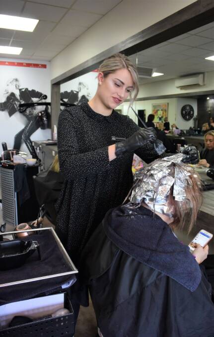 MAKING A DIFFERENCE: D’Coco Hair Studio hairdresser Shannon Jeffrey will help cut and blowdry hair on Sunday to raise money for the Style for Life initiative. Picture: DAINA OLIVER