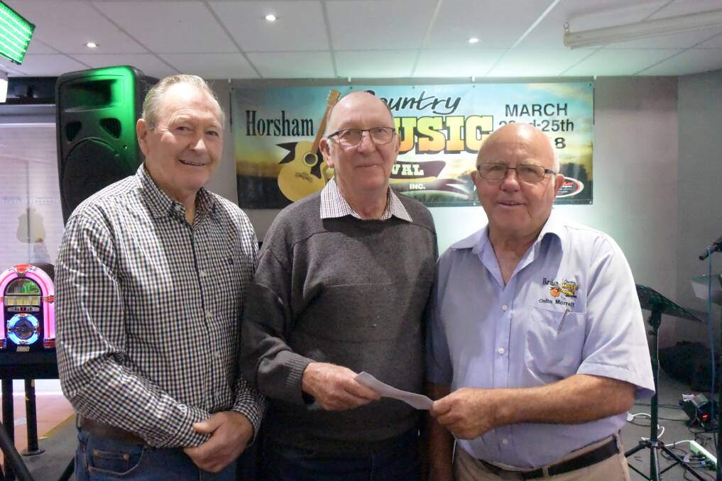 GENEROSITY: Wimmera Prostate Cancer Support Group's Max Judge, Brian Nagorcka with Horsham Country Music Association's Colin Morrell. Picture: DAINA OLIVER