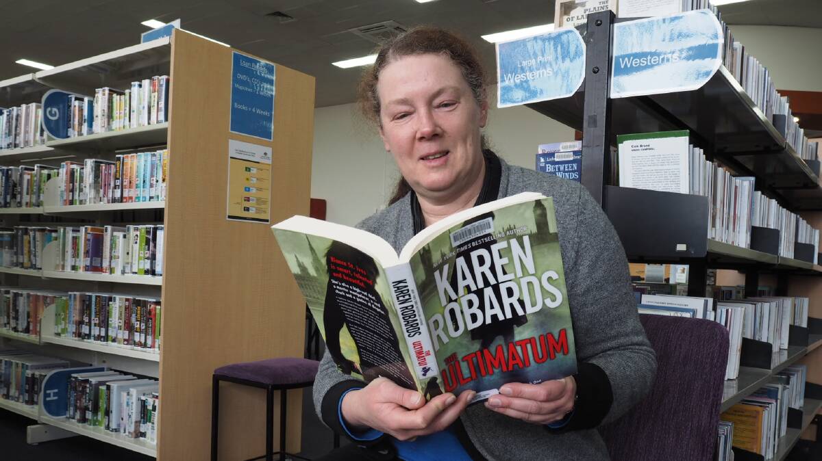 BOOKWORM: Wimmera Regional Library's Leanda Elliott getting stuck into a compelling read in preparation for the Australian Reading Hour on Thursday. Picture: DAINA OLIVER