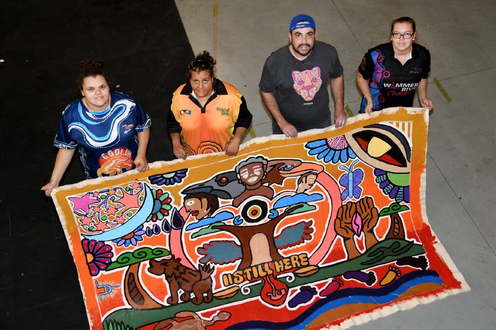 CREATIVE: Artists Kira Marks-Lovett, Lodi Lovett, Josh Muir and Tanisha Lovett with a mural they painted. Picture: SAMANTHA CAMARRI