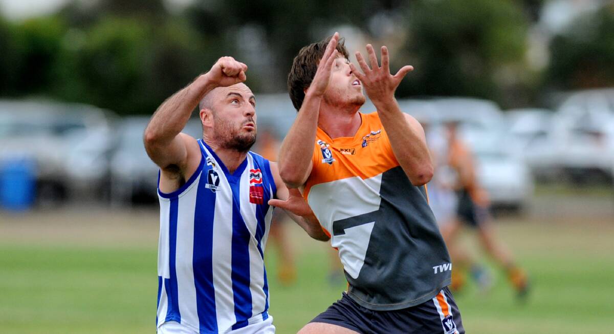 BATTLE: Southern Roo Dalton Burns attempts to punch the ball away from Giants' Tim Sanford. Picture: SAMANTHA CAMARRI 