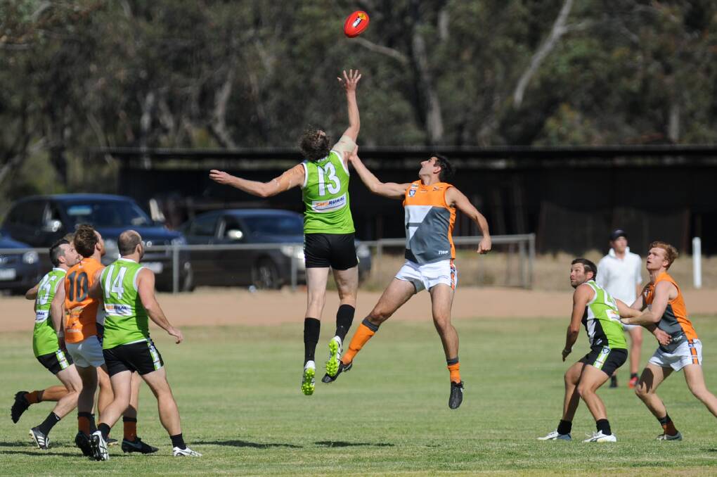 ON BALL: Sam Cranna leaps higher than Simon Cook in the ruck. The round 12 clash between the two sides will be won and lost in the midfield.