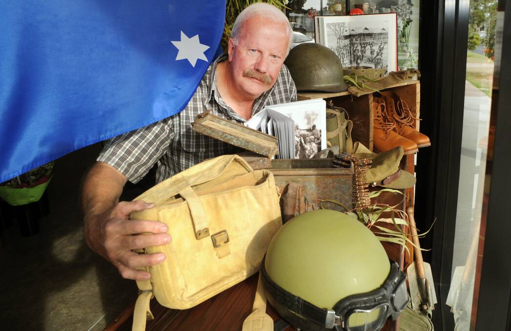 PASSION: War memorabilia collector Ray Buckley with a war display in Pick A Posie getting ready to take part in the Anzac Day march. Picture: PAUL CARRACHER