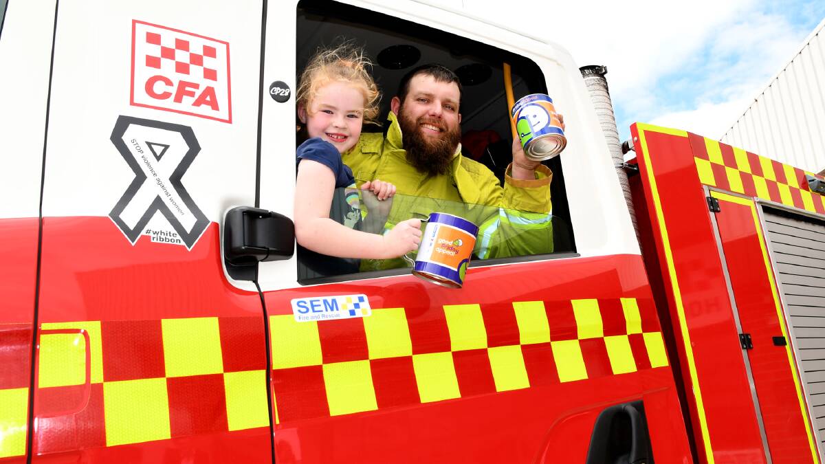 READY TO GO: Bella St Clair, 5, with Horsham firefighter Stephen Carman prepare for the Good Friday Appeal. Picture: SAMANTHA CAMARRI